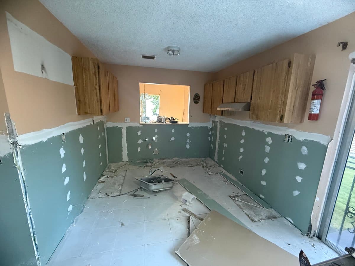 New drywall behind the cabinets on a kitchen remodel in South Miami Heights